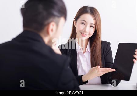 Business women are introducing or consulting businesses to male employees with mobile tablet Stock Photo