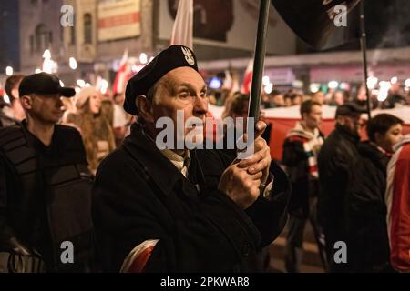Wroclaw, Dolnoslaskie, Poland. 11th Nov, 2014. An elderly man seen marching with a polish flag during the protest. On 11 November, Polish Independence Day, large Independence March has been organized. The protesters are calling for a return to traditional Polish values and identity, often invoking Catholicism and nationalism as important parts of their worldview. Many of them subscribe to far-right political ideologies and are affiliated with organizations such as National Revival of Poland and All-Polish Youth and football hooligans. However, it should be noted that not all participants in Stock Photo