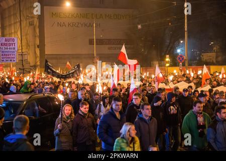 Wroclaw, Dolnoslaskie, Poland. 11th Nov, 2014. Demonstrators hold polish flags during the protest. On 11 November, Polish Independence Day, large Independence March has been organized. The protesters are calling for a return to traditional Polish values and identity, often invoking Catholicism and nationalism as important parts of their worldview. Many of them subscribe to far-right political ideologies and are affiliated with organizations such as National Revival of Poland and All-Polish Youth and football hooligans. However, it should be noted that not all participants in the march may h Stock Photo