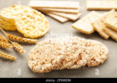 Different types of crispbread on grey background. Top view Stock Photo