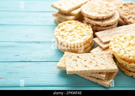 Different types of crispbread on blue wooden background. Top view Stock Photo