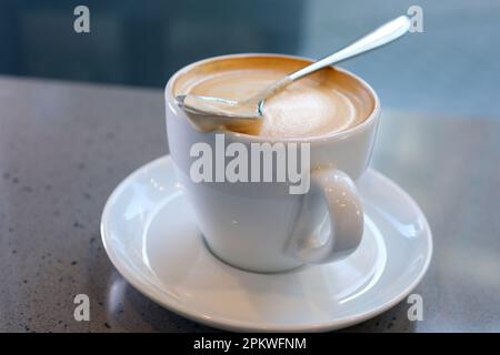 cup of coffee latte in shape of heart and coffee beans on an old wooden background Eating Foam Or Thick Froth Of Hot Coffee Latte large cup of cappuccino coffee with milk foam in the morning overhead Stock Photo