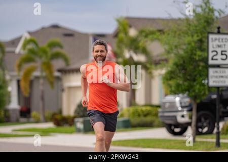 Man runner on the street with raining be running for exercise. Run for ...