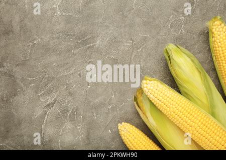 Fresh corn on cobs on rustic wooden table, closeup. Ripe corn. Stock Photo