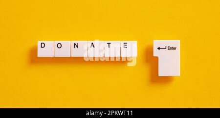 Online donation, charity and relief work concept. Computer keyboard keys with the word donate. Stock Photo