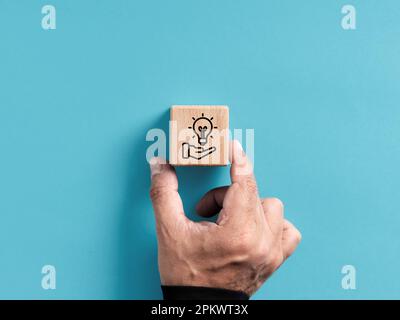 New idea or solution suggestion concept. Creative strategy suggestion for business success and growth. Hand places the wooden cube with new idea sugge Stock Photo