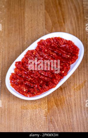 Chili paste. Hot snack prepared with pepper paste in a ceramic bowl. close up Stock Photo