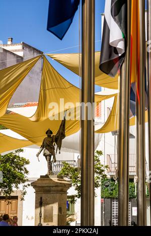Villanova de la Serena, Spain - 26 June 2022: Square with shade cloths and statue to Pietro de Valdivia in Villanova de la Serena (Spain) Stock Photo