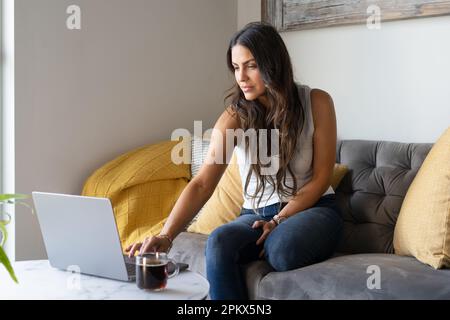 Woman working From Home On The Sofa Stock Photo