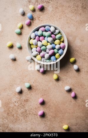 Top view of bowl of colorful mini chocolate eggs for easter. Stock Photo