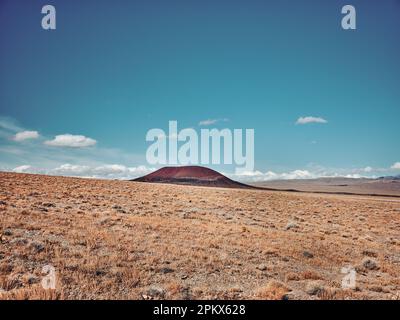 An ancient cinder cone in a dry lake bed formed from a volcano Stock Photo