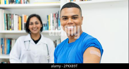 Handsome mexican young adult man after vaccination at hospital Stock Photo
