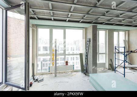 Man assembles profile metal frame for plasterboard ceilings Stock Photo
