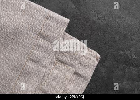 Linen kitchen towel napkin or textile tablecloth fabric on gray concrete table background. Top view Stock Photo