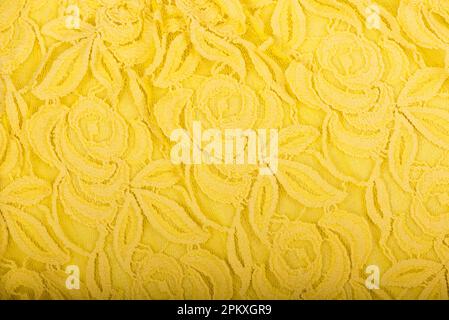Canvas background, golden yellow fabric texture background, lace pattern detail. Golden yellow fabric texture for background, natural textile pattern. Stock Photo