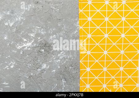 top view with yellow empty kitchen napkin isolated on table background. Folded cloth for mockup with copy space, Flat lay. Minimal style. Stock Photo