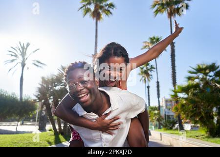 Cheerful portrait of a young African American couple on their holidays on an island. Stock Photo