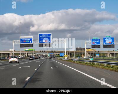 Direction information on overhead gantries, orbital motorway A2 traffic junction Oudenrijn, Utrecht, Netherlands Stock Photo