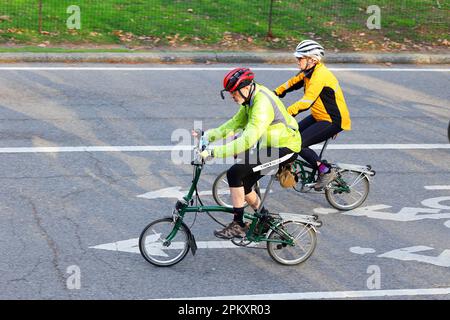 An older couple riding Brompton foldable bicycles. Active seniors riding bicycles. Stock Photo