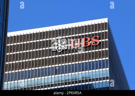 The logo of UBS AG can be seen from the street near their 1285 6th Ave headquarters building in New York City. Stock Photo