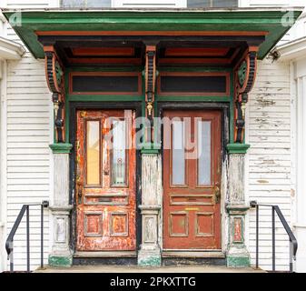 detail image of a pair of old exterior doors with intricate trim work Stock Photo