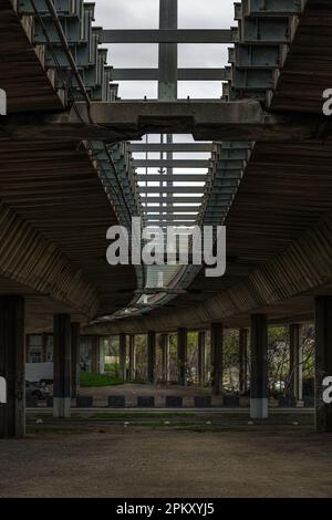 Brutalist architecture style example, low angle view of large concrete overpass bridge, selective focus Stock Photo