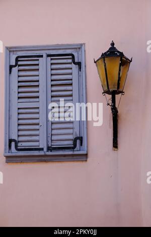 Window with shutters and street lamp in Athens Stock Photo