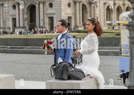 Celebrating Love in the City of Romance: A Beautiful Couple Embracing their Special Day in Paris Stock Photo