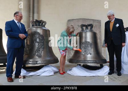 Magdeburg, Germany. 10th Apr, 2023. Simone Borris (center), mayor of Magdeburg, strikes the second 'Benedicamus' bell in the cathedral. Five newly cast bells for the ringing of Magdeburg Cathedral were presented and inaugurated on Easter Monday. Credit: Peter Gercke/dpa-Zentralbild/dpa/Alamy Live News Stock Photo