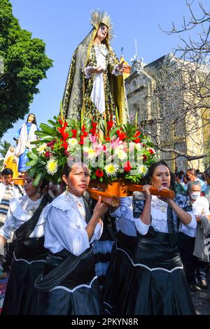 Female churchgoers carry the palanquin of Virgin Mary during during the Good Friday religious procession, City of Oaxaca, Mexico Stock Photo