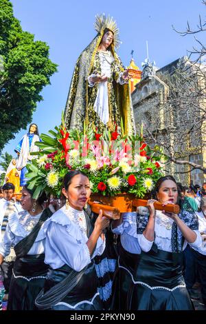 Female churchgoers carry the palanquin of Virgin Mary during during the Good Friday religious procession, City of Oaxaca, Mexico Stock Photo