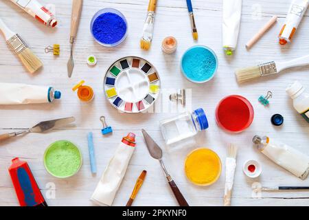Painting equipment on white wooden background - top view Stock Photo