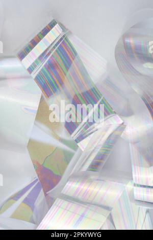 From above hip of thin strips of shiny holographic foil Stock Photo