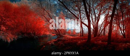 Picturesque landscape with vibrant red infrared effect of frosted trees growing on shore of peaceful forest lake under clear blue sky in sunny winter Stock Photo