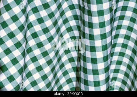 Full frame background of bright green and white checkered tablecloth arranged on table Stock Photo