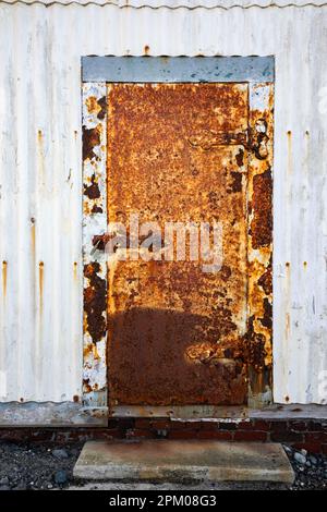 WA23278-00...WASHINGTON - Rusted door on a supply shed at Point Wilson Lighthouse located in Worden State Park in Port Townsend. Stock Photo