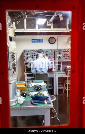 A mannequin simulates a radio operator on board the aircraft carrier USS Yorktown at Patriot's Point Naval and Maritime Museum in Mount Pleasant, SC. Stock Photo