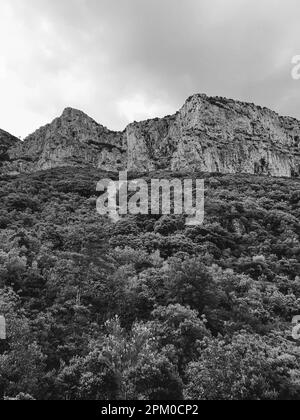 A grayscale shot of mountains near of a small village in the south of France called Saint Guilhem of Desert Stock Photo