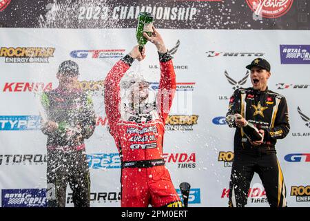 Matt Field, Rome Charpentier and Fredric Aasbo spray champagne after receiving their medals and cheques for their placement at Formula Drift Long Beach. For the 20th consecutive season Formula Drift kicks off the start to the 2023 Pro Championship competition in downtown Long Beach, California. Hosting a two day event with the qualifying rounds beginning on Friday April 7th, and concluding with championship competition on April the 8th. Drivers from across the globe battled it out in a Smokey and high horsepower fight to the top with only the toughest able to make it through each round. With t Stock Photo