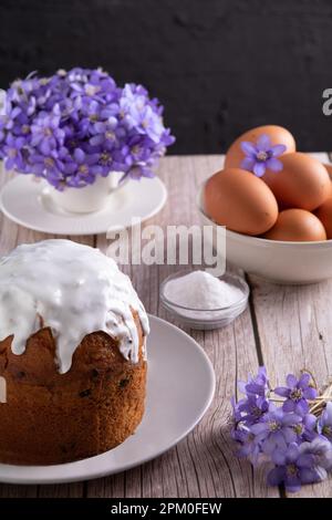 photo of Easter sponge cake, eggs and flowers on the table Stock Photo