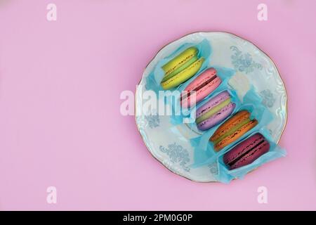 Marshmallows in plate on pink background. Traditional colored sweet desserts for the holiday. Stock Photo
