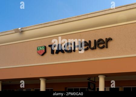 Close up of TAG Heuer store sign on building is shown. Stock Photo