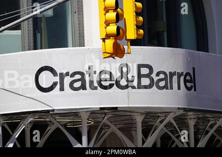 New York, NY - April 9, 2023 : Crate and Barrel home furnishings Downtown SoHo Manhattan store sign with logo and yellow traffic light Stock Photo