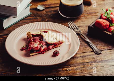 Portion of Strawberry and Sorrel Galette on Plate with Glass of Stout Stock Photo