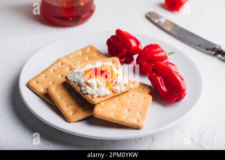 Hot habanero sauce with cream cheese on crackers Stock Photo