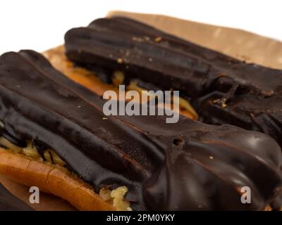 Delicious chocolate eclairs isolated on white background. Eclairs Close-up. Stock Photo