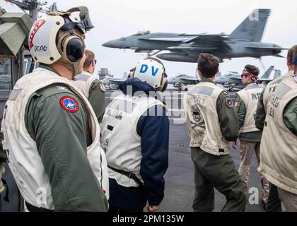 230408-N-IX644-2267 MEDITERRANEAN SEA (April 8, 2023) Capt. Guyenc Uysal, chief of staff, Turkish Navy, observes flight operations with the landing signal officers aboard the Nimitz-class aircraft carrier USS George H.W. Bush (CVN 77), April 8, 2023. The George H.W. Bush Carrier Strike Group is on a scheduled deployment in the U.S. Naval Forces Europe area of operations, employed by U.S. Sixth Fleet to defend U.S., allied, and partner interests. (U.S. Navy photo by Mass Communication Specialist Seaman Sasha Ambrose) Stock Photo