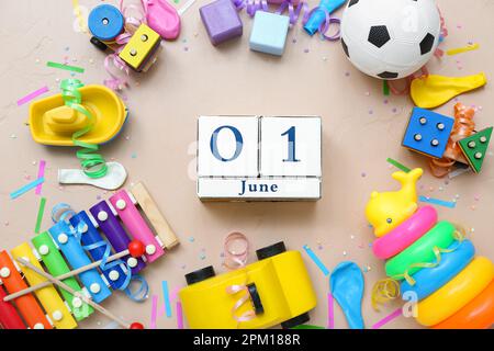 Date of Children's Day with toys on beige background Stock Photo