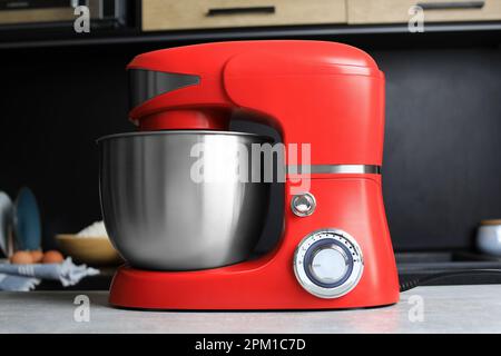 White kitchen machine and stand mixer on a wooden table in a bright design  apartment Stock Photo - Alamy