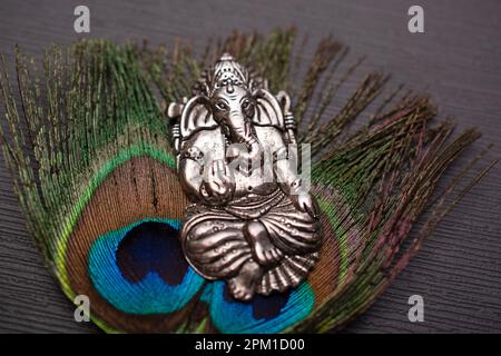 Lord ganesh silver ornament with peacock feather Stock Photo